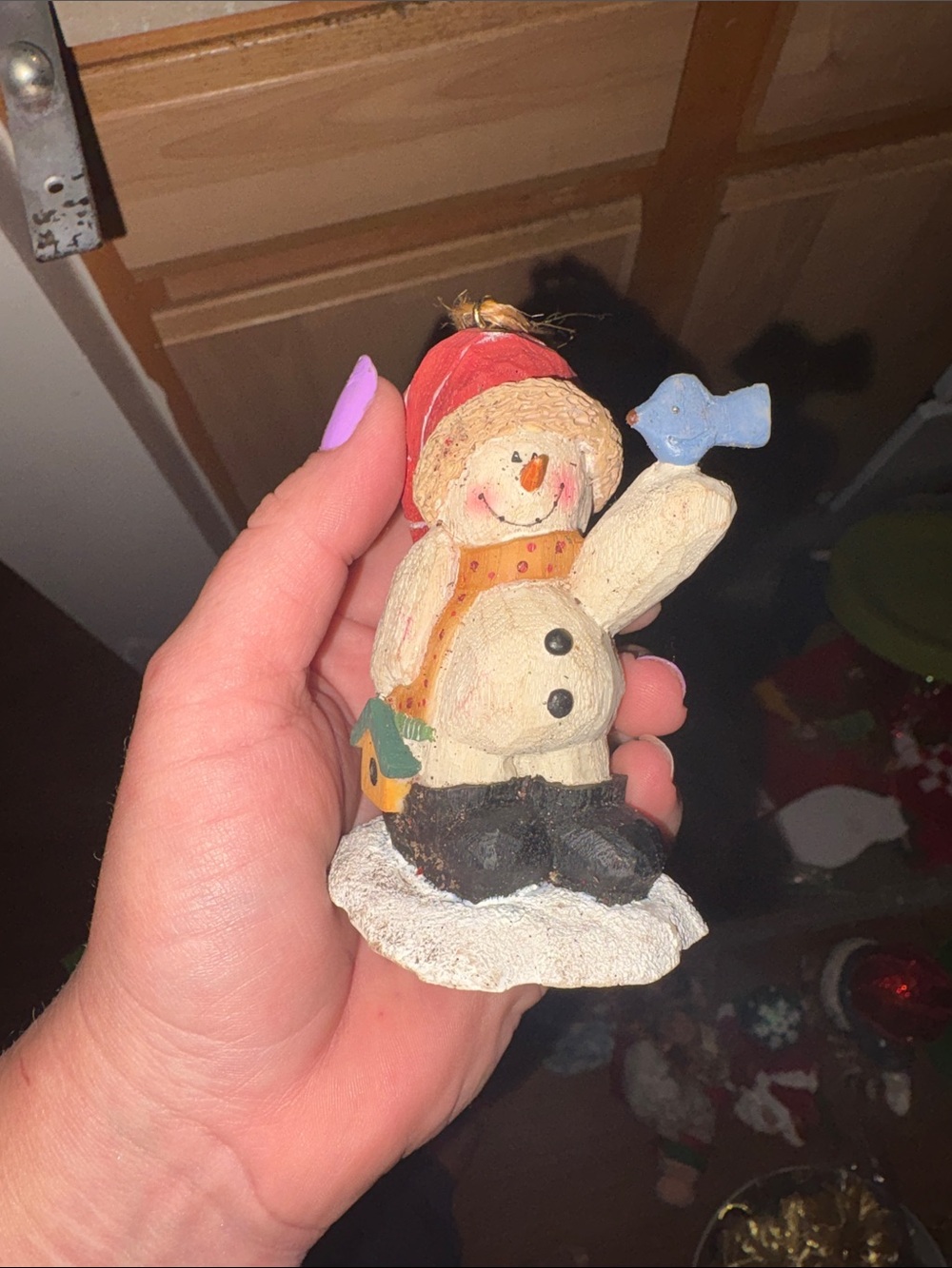 Handheld Snowman Figurine with Red Hat and Blue Bird